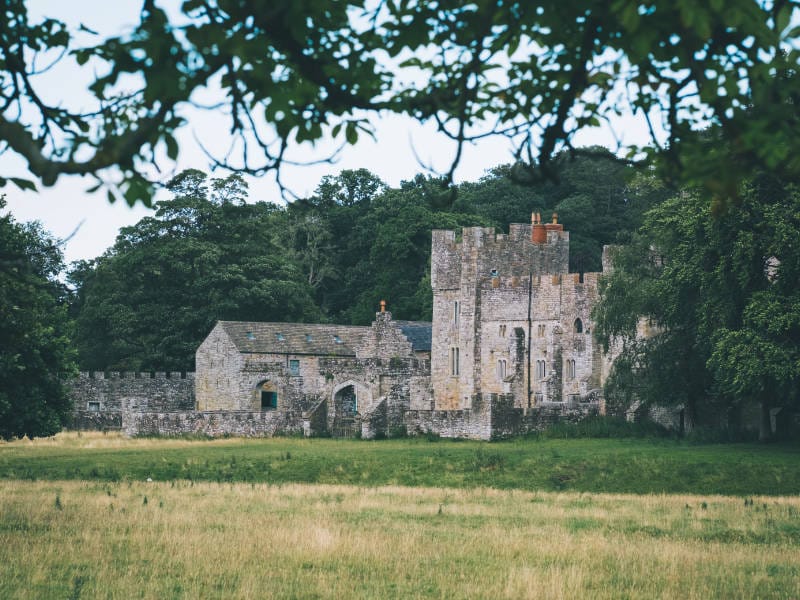 A view of Featherstone Castle from across the fields.